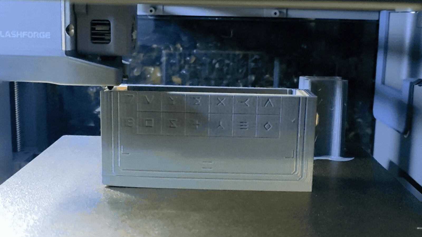 A real 3D printer depositing filament on a book prototype.