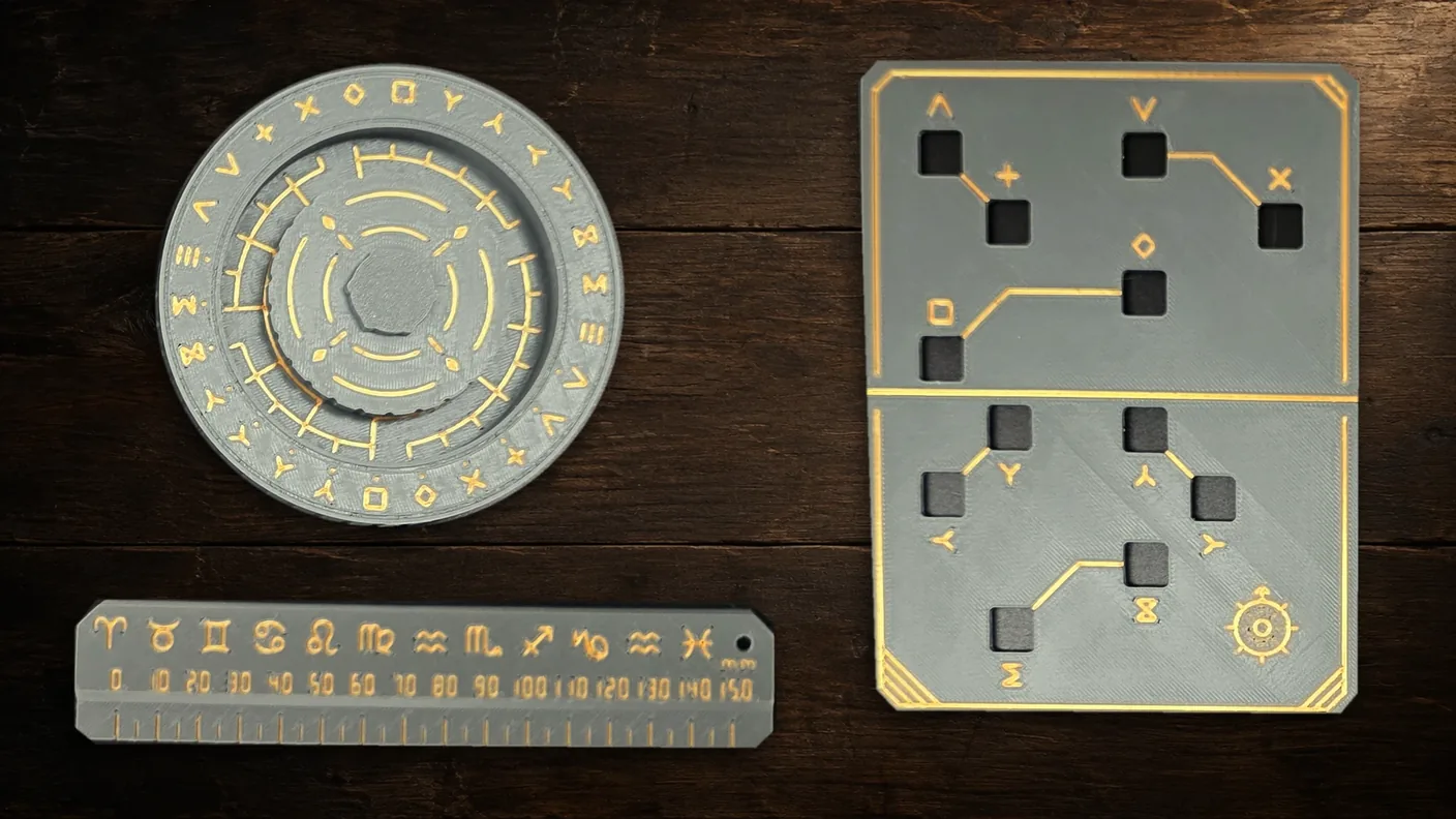 A grey and gold cipher wheel, grille and ruler on a dark wooden workbench.